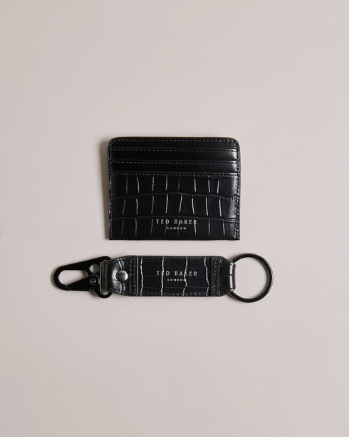 ROMAIIN-Gifts-Keep your keys and cards organized with our ROMAIIN set. Made from high-quality leather featuring a sophisticated croc texture, these accessories are the epitome of understated luxury. With a glossy finish that catches the eye, this set not only keeps your essentials in check but also adds a stylish edge to your everyday carry. Key fob and card holder set Leather Croc texture Hinge clip Logo detail Glossy finish- Ted Baker Romania